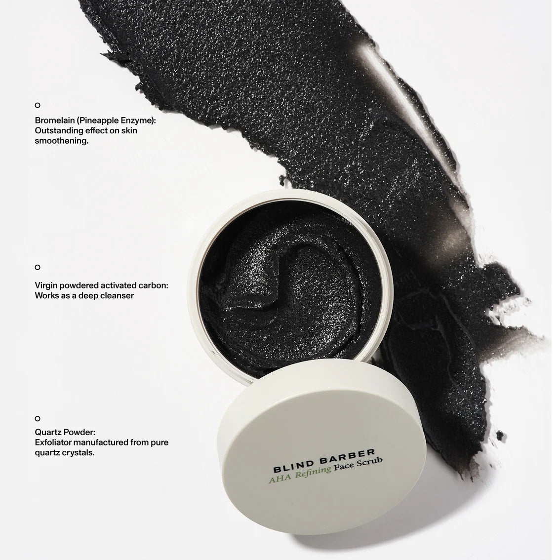 Blind Barber AHA Refining Face Scrub with black powder on a white background