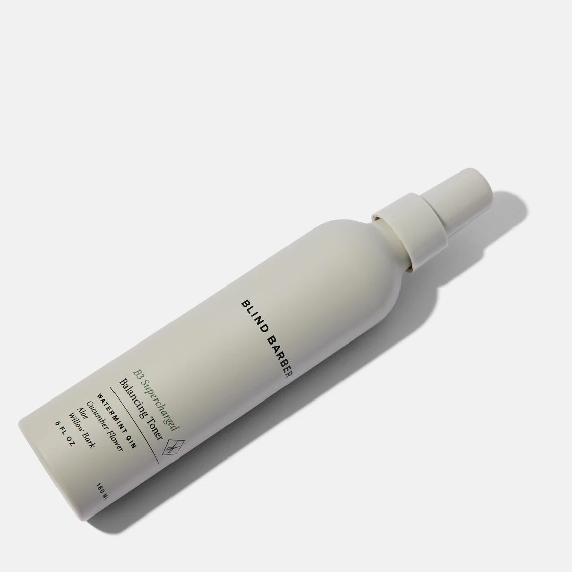 White skincare bottle with 'Blind Barber' branding on a white background