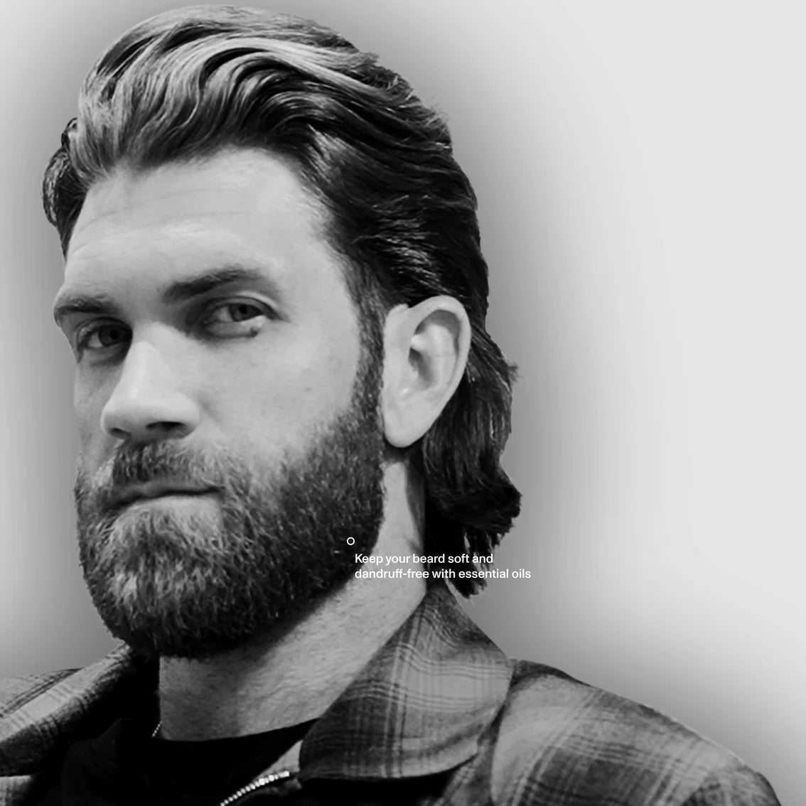 Black and white portrait of a man with a beard and plaid shirt, with text about essential oils.