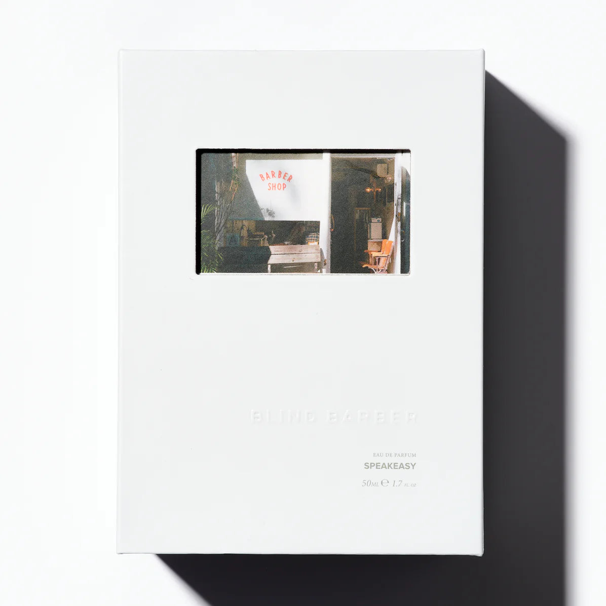 White box with a small window displaying images of a store interior.