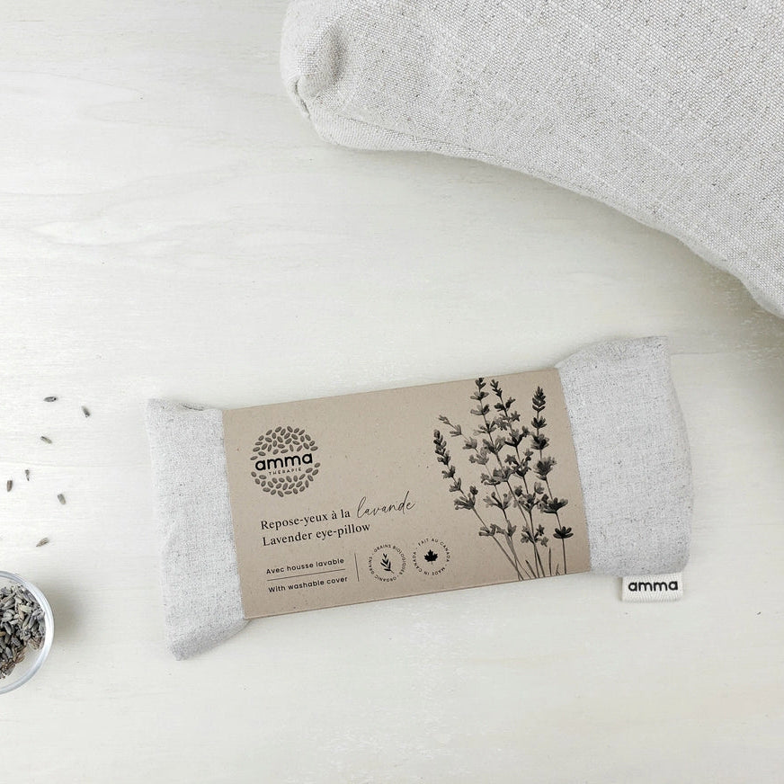 Gray lavender eye pillow with packaging on a white background
