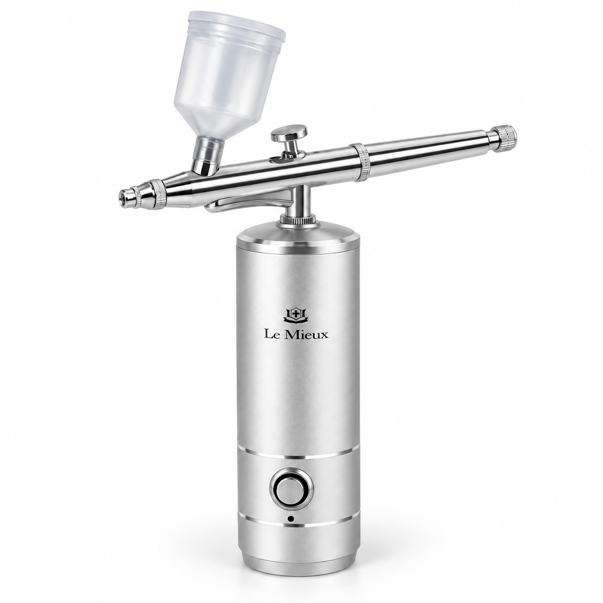 A Le Mieux airbrush spray gun with a brushed silver metal cylinder body, a polished stainless steel spray barrel, and a translucent plastic paint cup, shown on a clean white background.