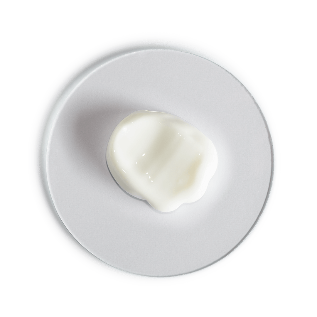 Heart-shaped white cream on a white plate with a black background