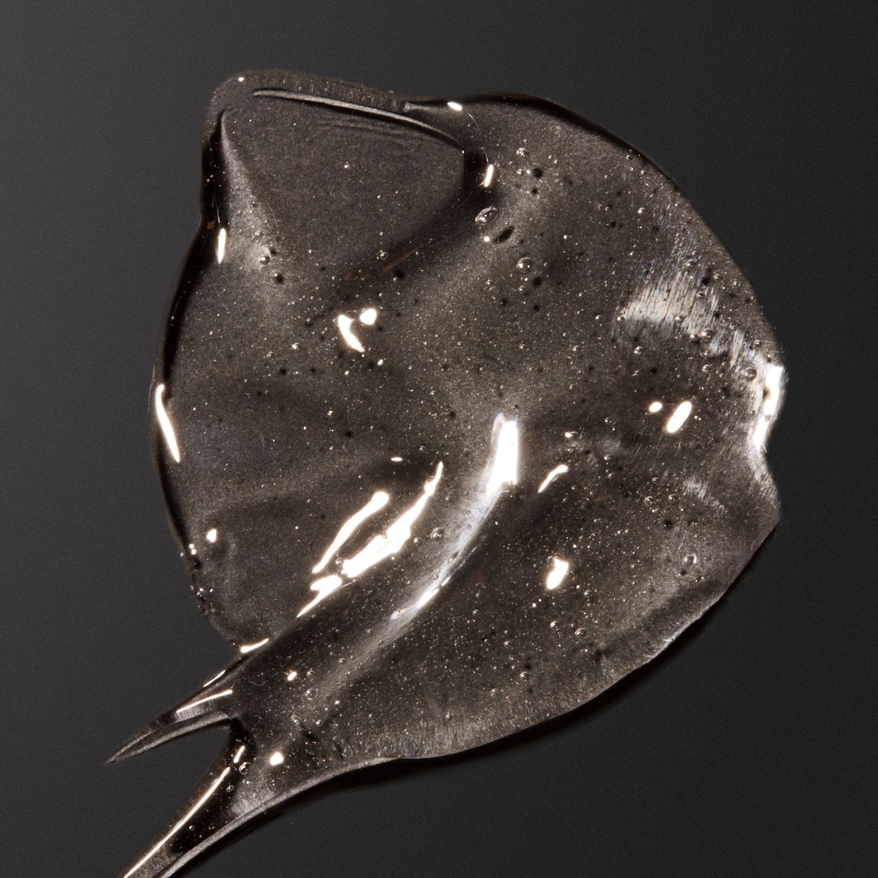 Close-up of a dark gray or black smear on a black background