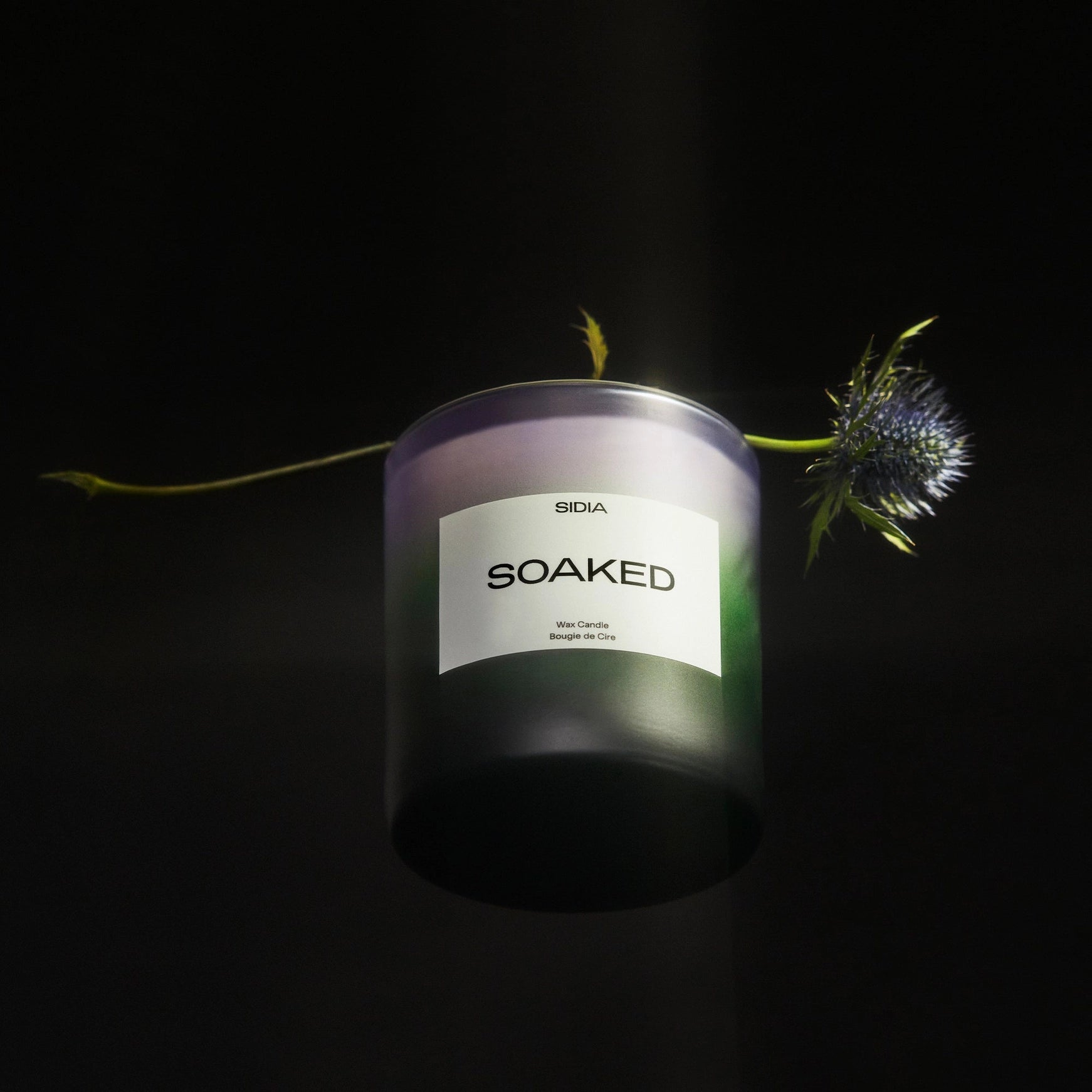 Candle labeled 'SOAKED' with a dark background