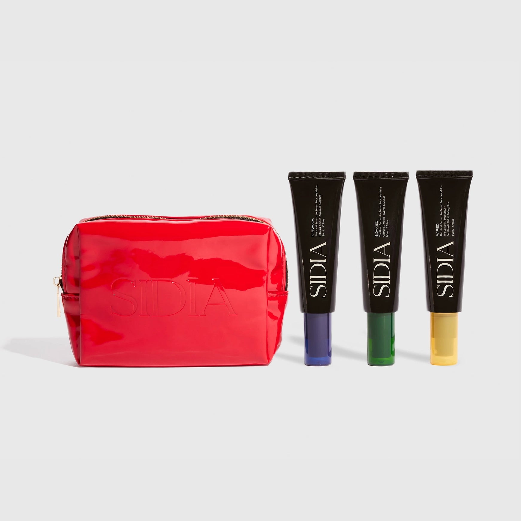 Red cosmetic bag with Sidiia skincare products on a light gray background