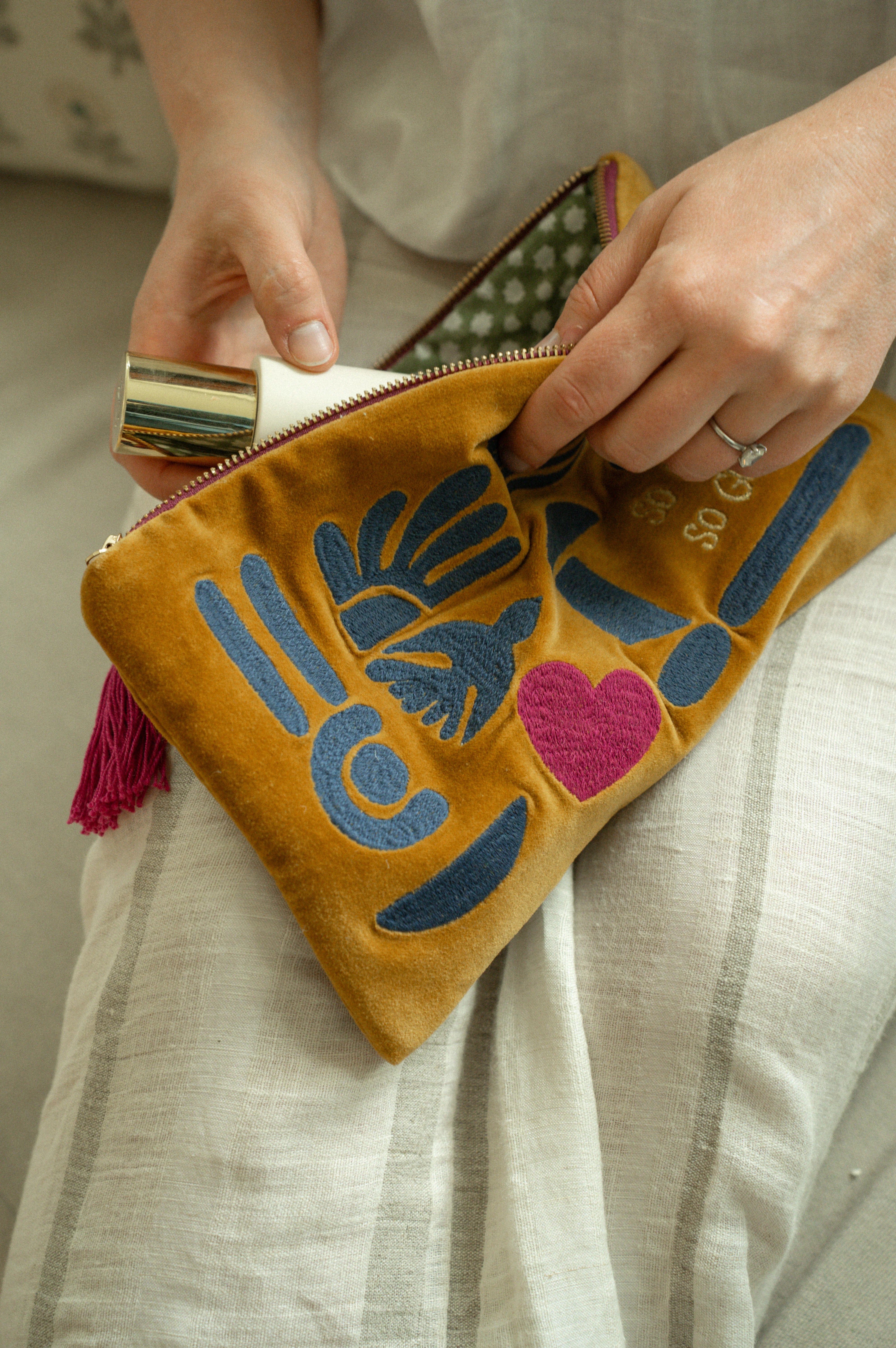 Indaba Spring Silhouettes cotton velvet pouch with colourful embroidery, tassel zipper and so far so good lettering