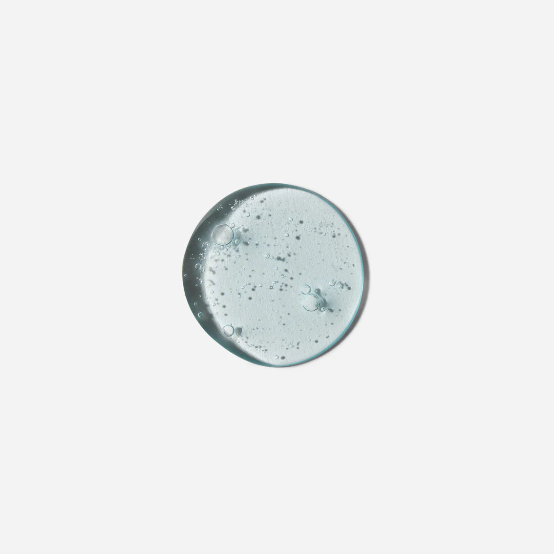 Clear gel-like substance with bubbles on a light gray background