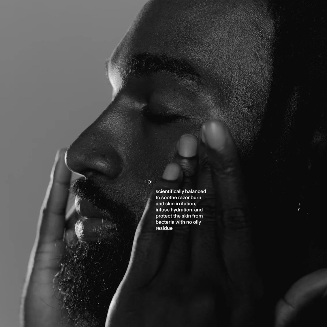 Black and white close-up of a person's face with text overlay on a gray background
