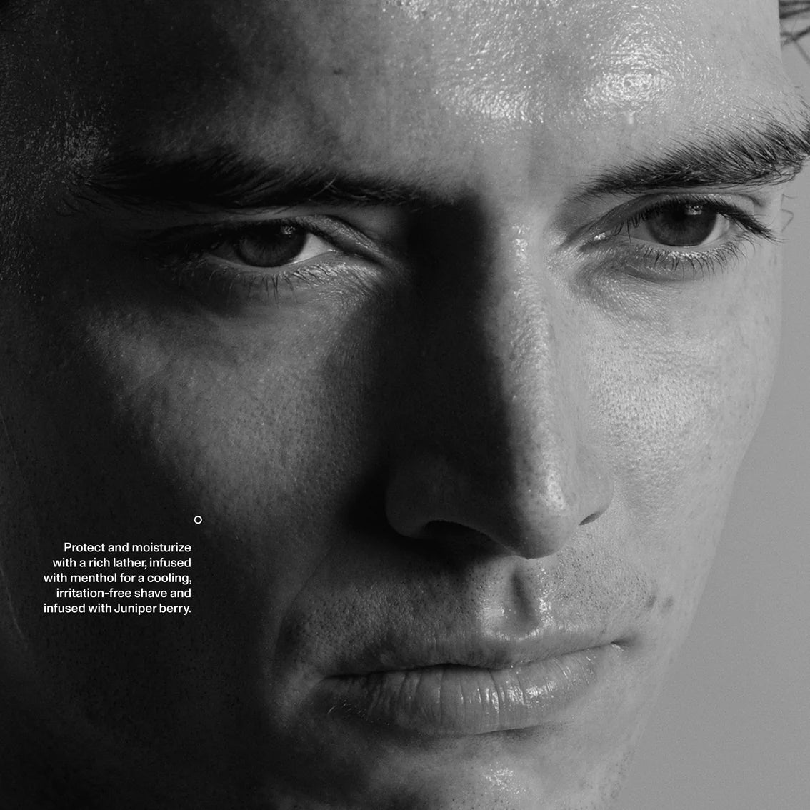 Close-up of a man's face with a black and white filter, highlighting the product's benefits.