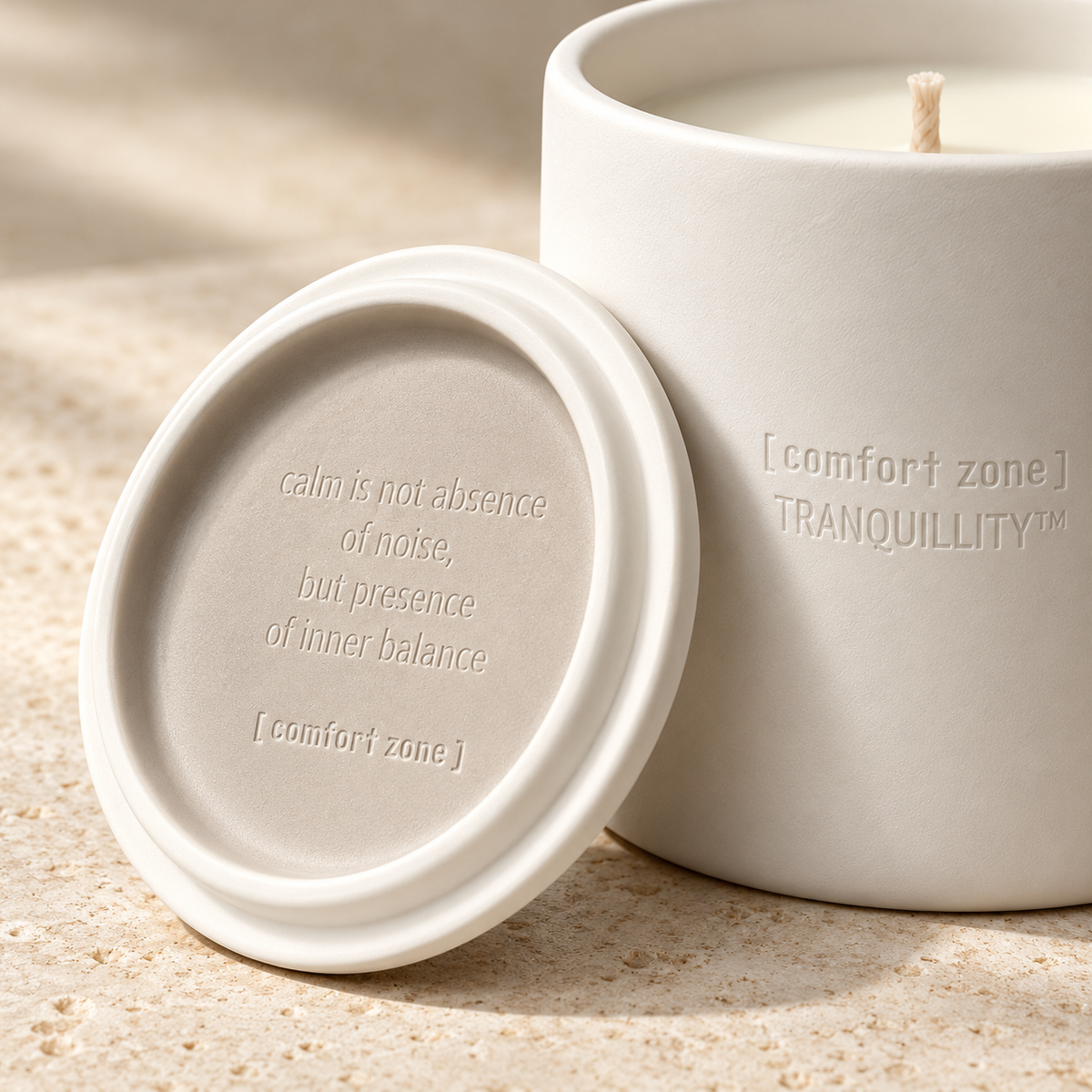 Close-up of the Holiday Tranquillity candle’s embossed ceramic vessel and inscribed lid