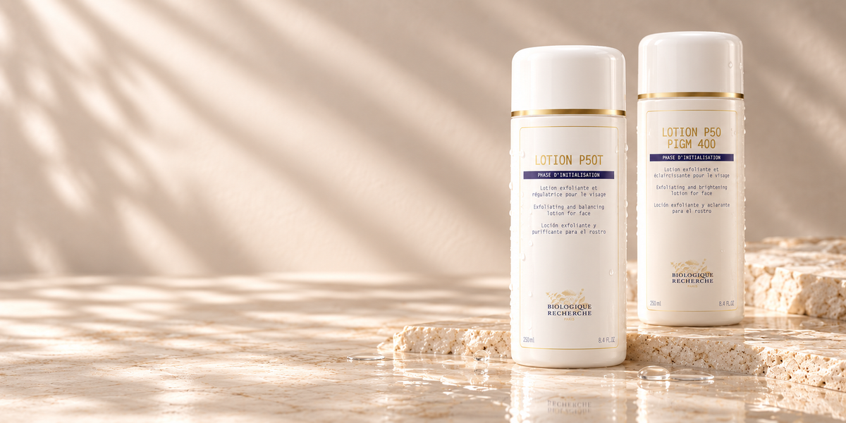 Biologique Recherche Lotion P50T and Lotion P50 PIGM 400 on a warm ivory stone surface.