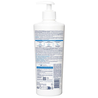 White bottle with pump and label on a white background
