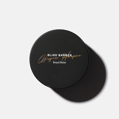 Black container of Blind Barber Bryce Harper Beard Balm on a light gray background
