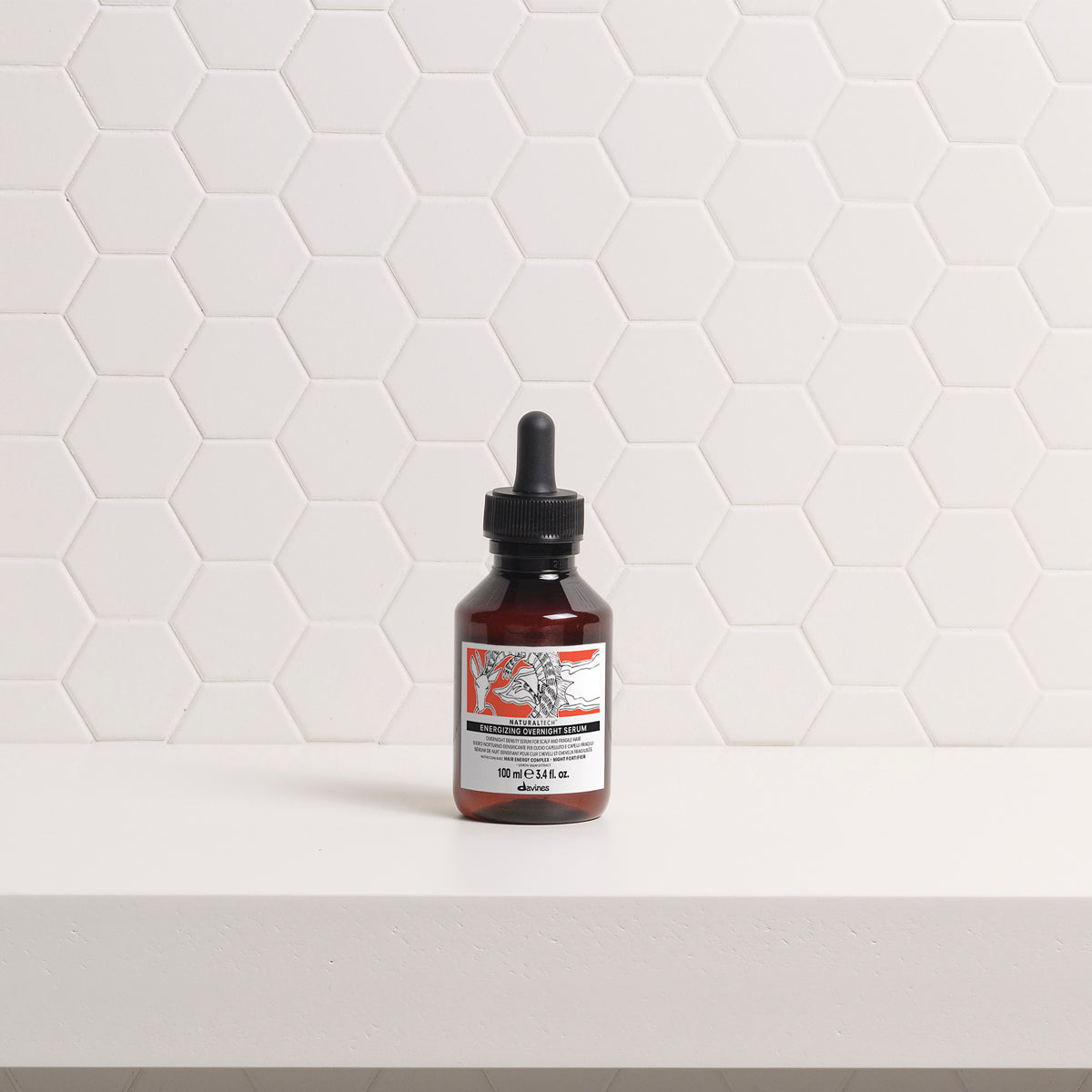 Davines ENERGIZING Overnight Serum bottle on a bathroom shelf