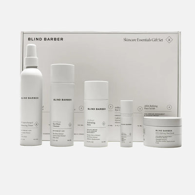 Blind Barber skincare products including bottles and a jar in front of a branded box on a white background.