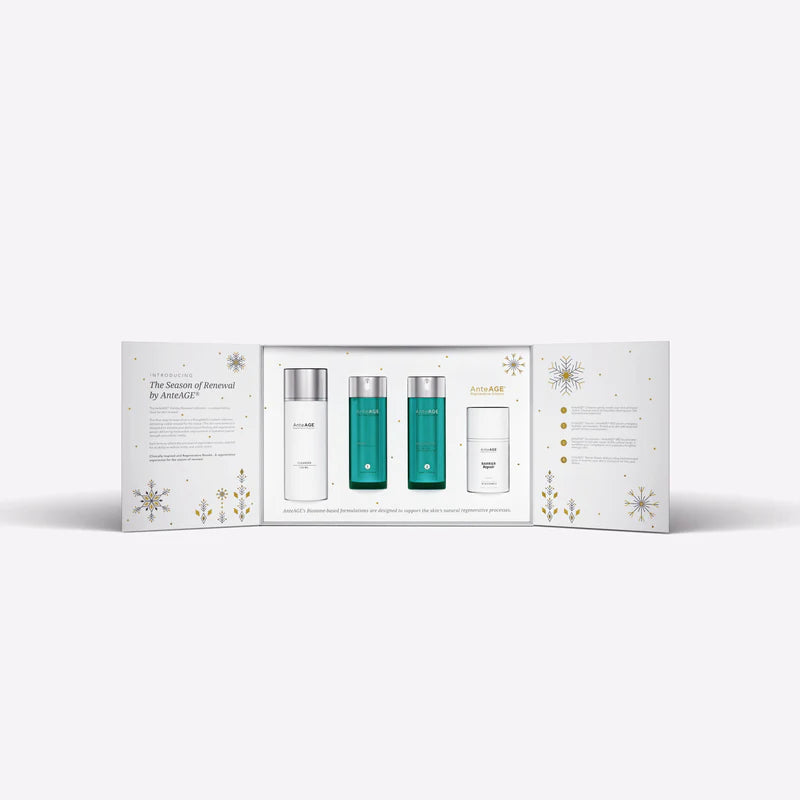 Skincare product set with three bottles in a decorative box on a white background