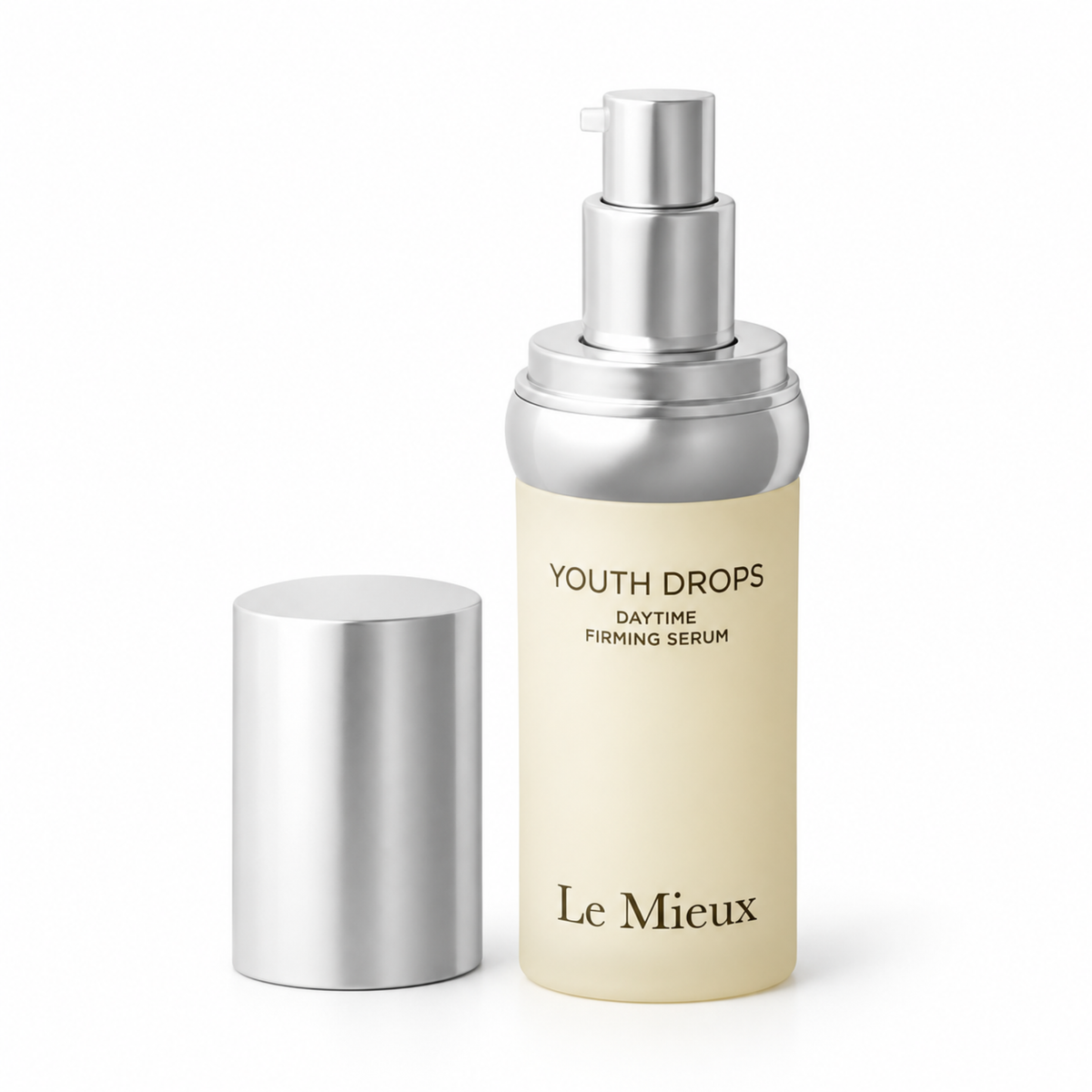 Le Mieux Youth Drops Daytime Firming Serum in a frosted beige bottle with a silver pump dispenser, shown with its silver cap beside it on a white background.
