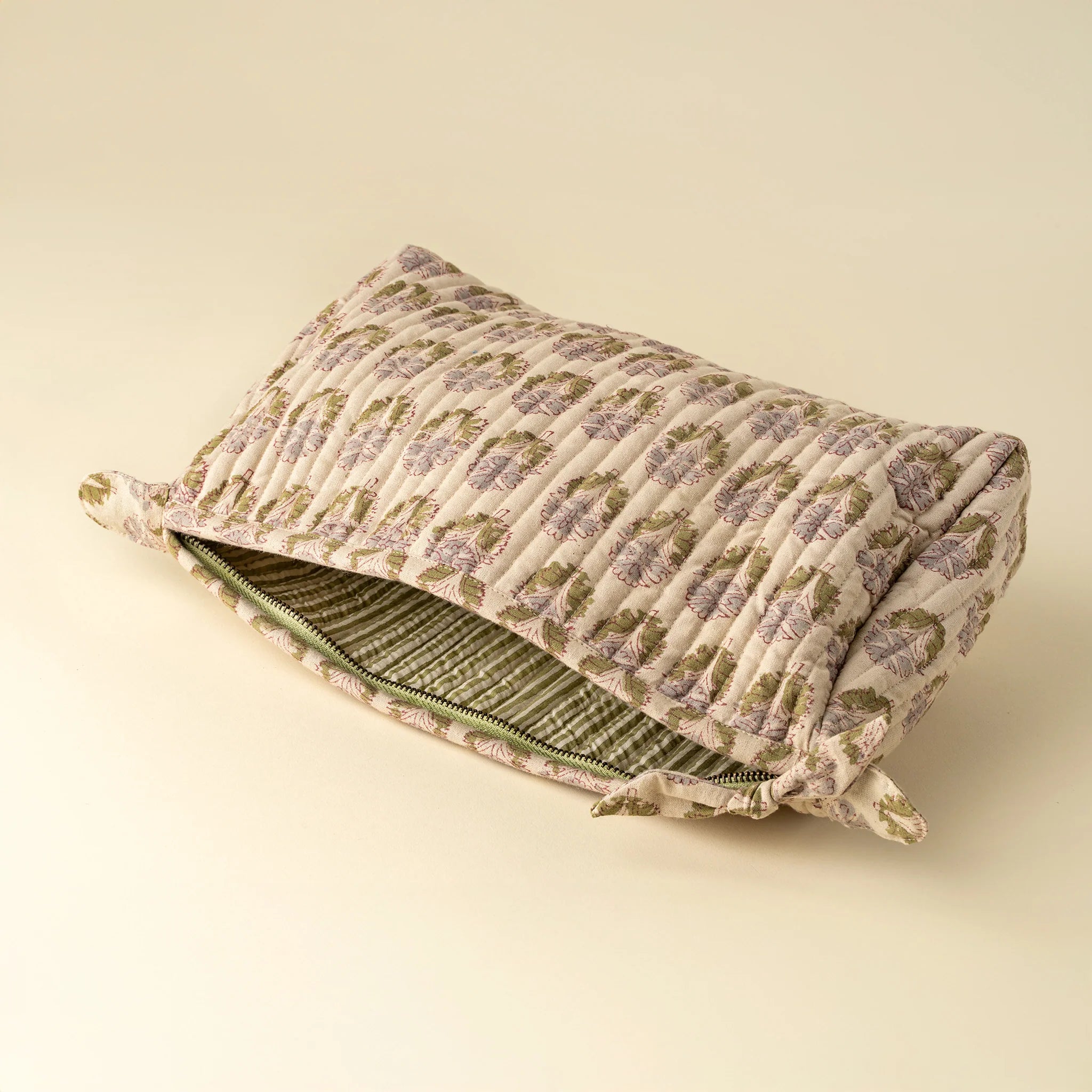 Floral-patterned pillow with a zipper on a beige background