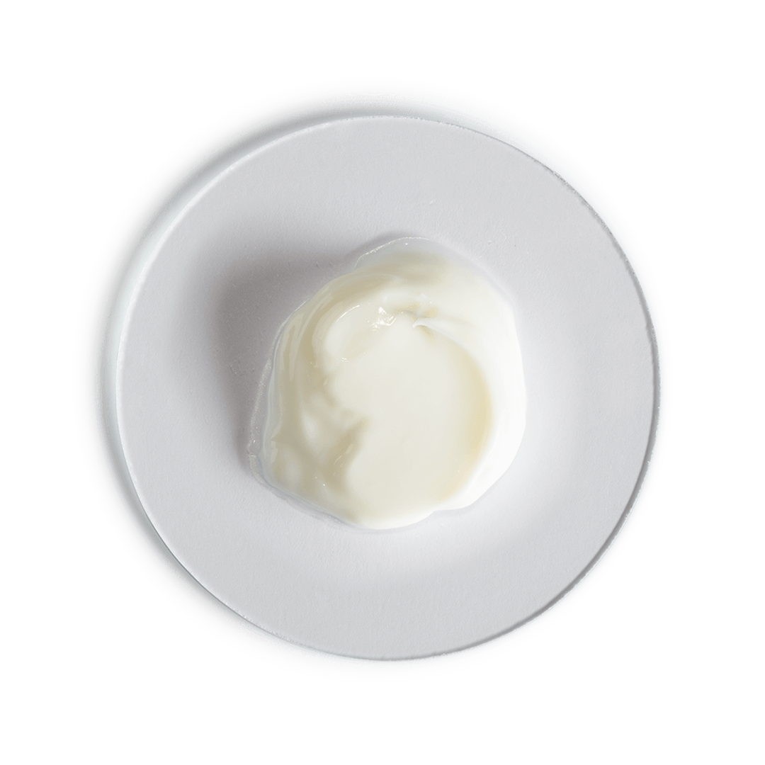White yogurt container on a white plate with a black background