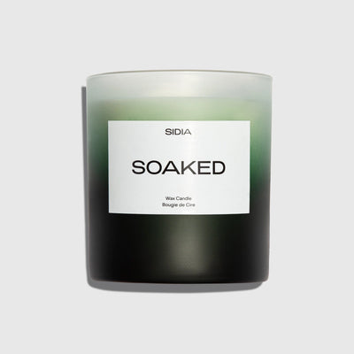 Candle labeled 'Soaked' by Sidia on a light gray background