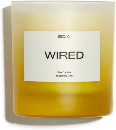 Candle labeled 'WIRED' by Sidia with a white label on a white background