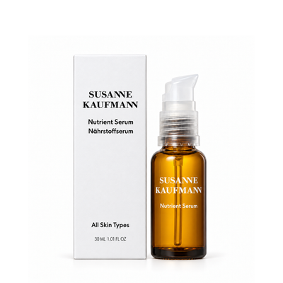 Susanne Kaufmann Nutrient Serum 30ml bottle in an amber glass bottle with a white pump dispenser, shown next to its white packaging box on a clean white background.