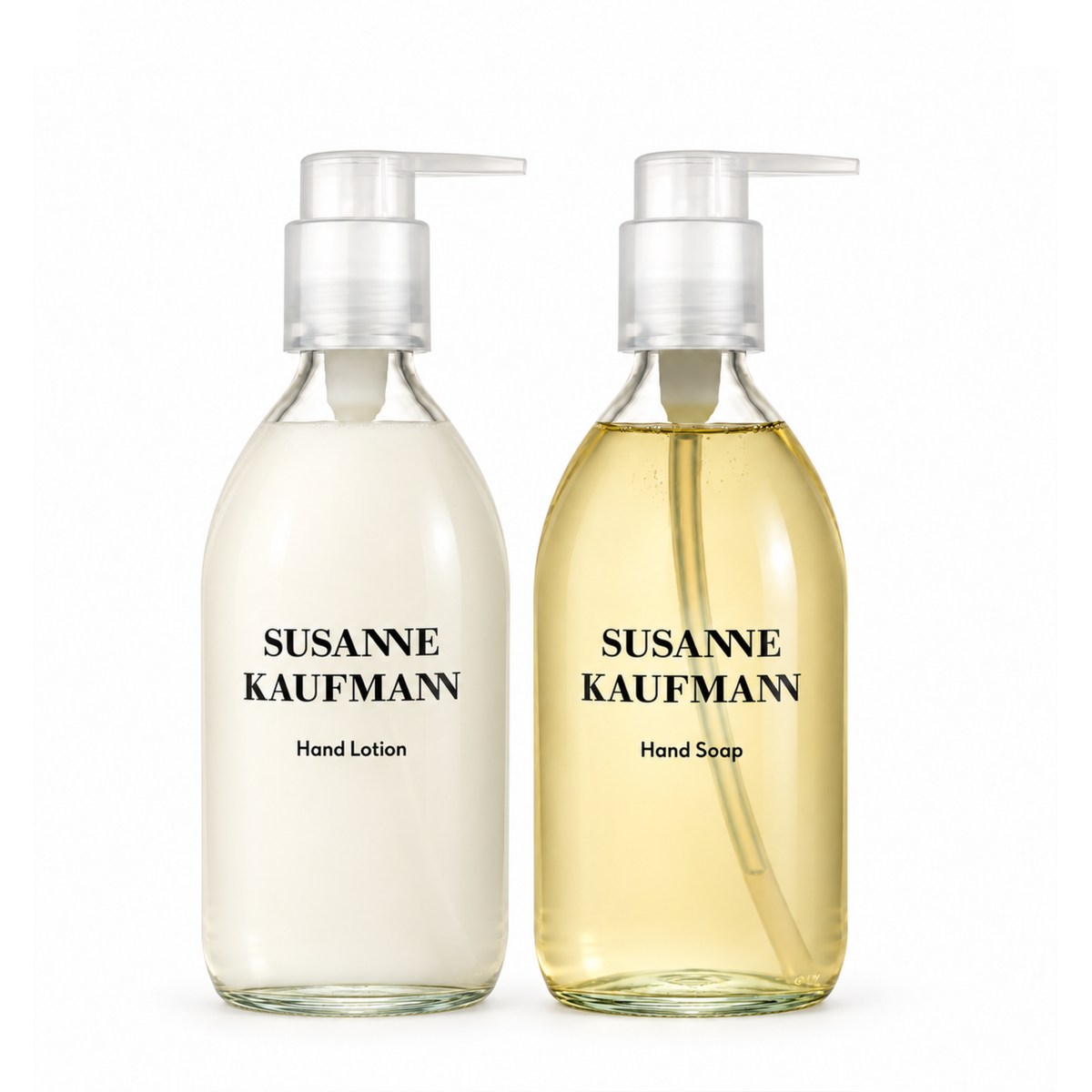Two clear pump bottles with white caps on a white background. The left bottle contains a milky white liquid labeled 'SUSANNE KAUFMANN Hand Lotion' and the right bottle contains a pale yellow liquid labeled 'SUSANNE KAUFMANN Hand Soap'.