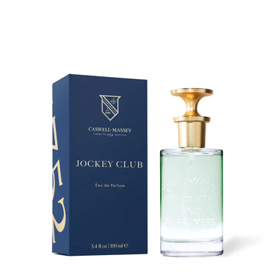 Eau de parfum Jockey Club Caswell-Massey, flacon de 100 ml à côté de sa boîte bleu marine