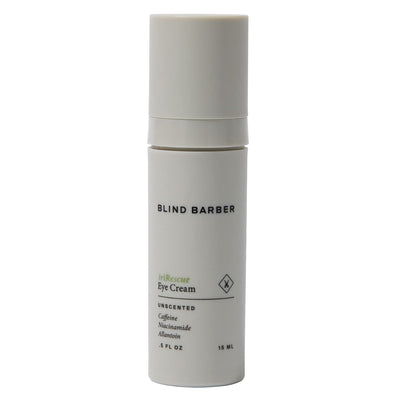 White eye cream bottle with 'Blind Barber' branding on a white background